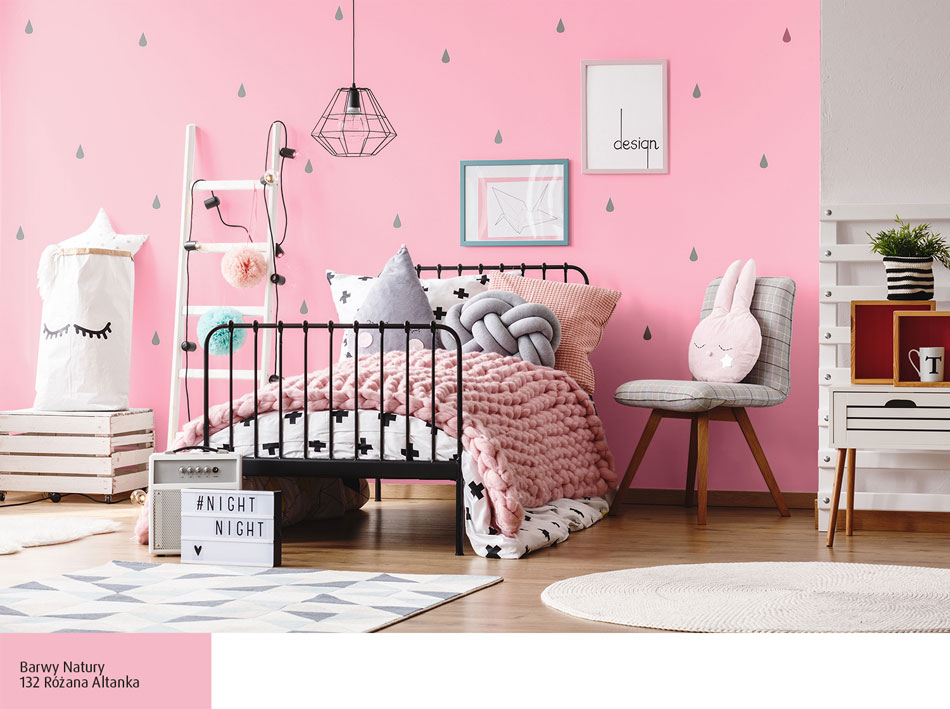 Różowa ściana za łóżkiem w pokoju dziecka